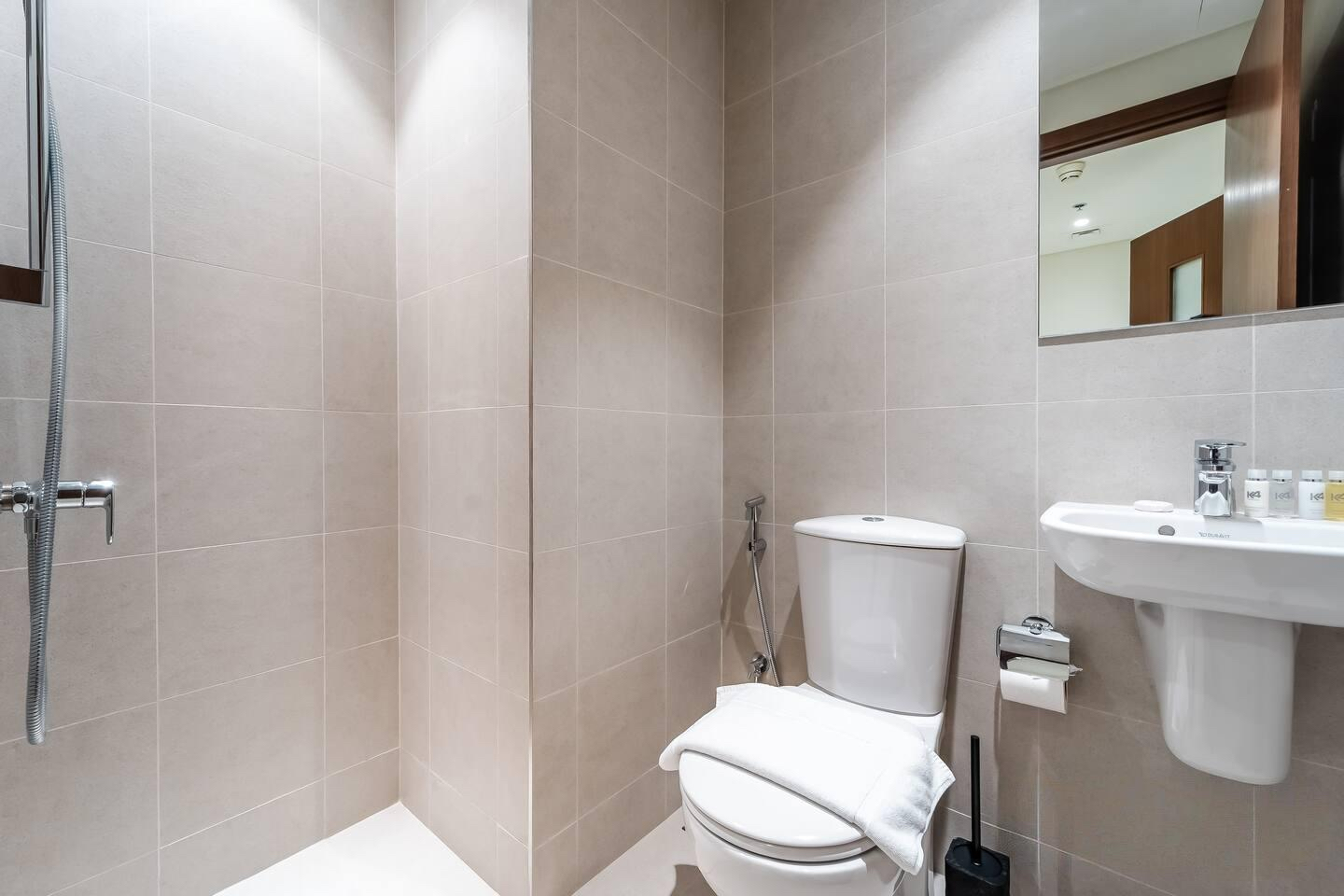 Toilet with seat and tool in bathroom