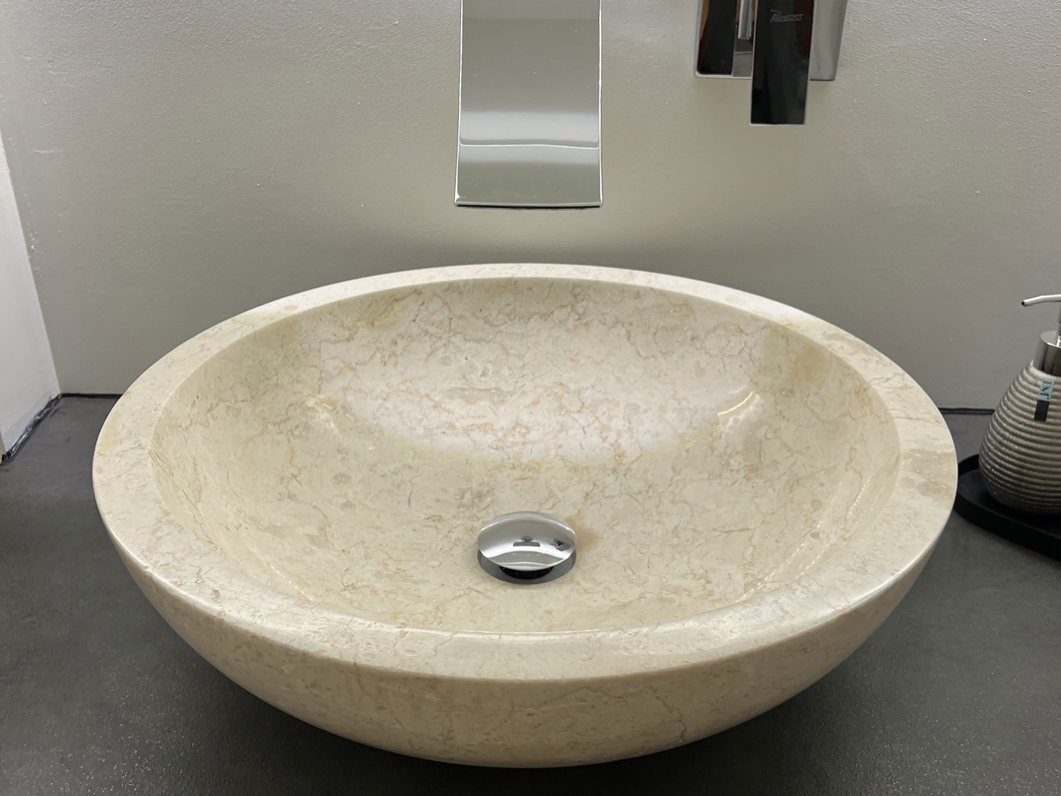 A bathroom with a washbasin and faucet