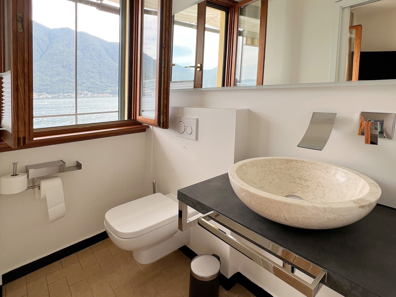 Bathroom interior with window, seat, tool, washbasin, toilet