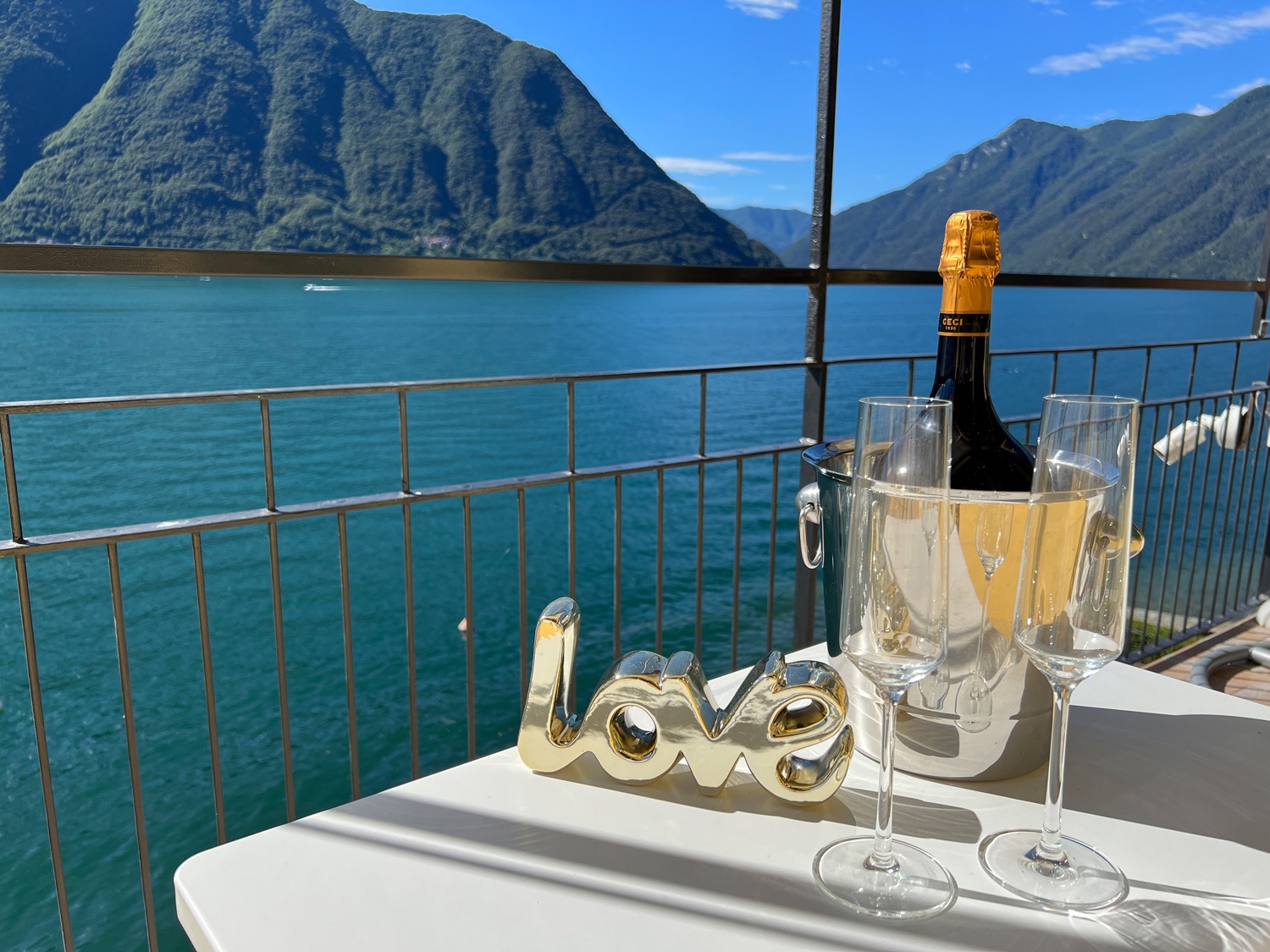 Blue cloudy sky above lake with fence