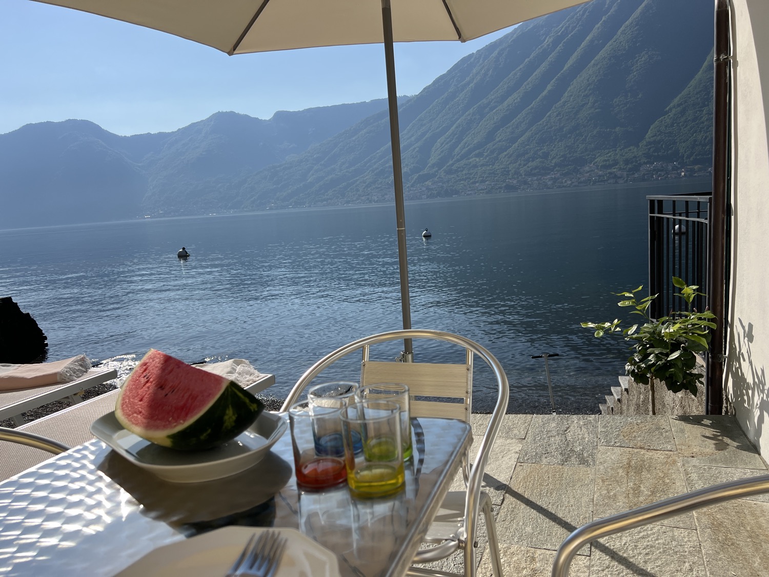 Umbrella on table, utensils, drinks