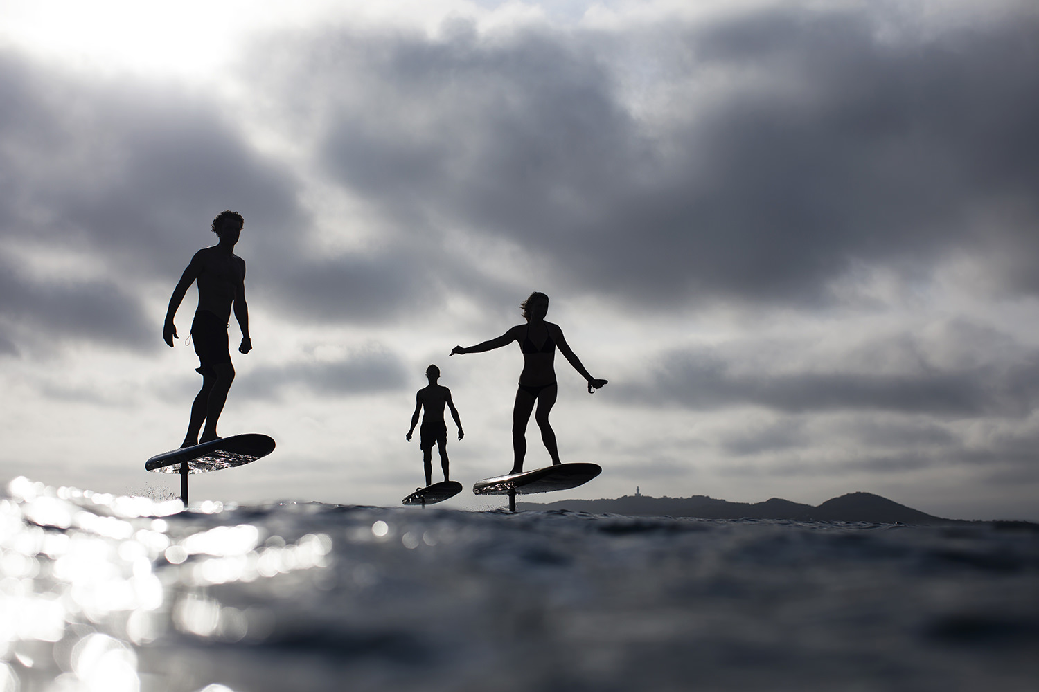 People surf outdoors under cloudy sky
