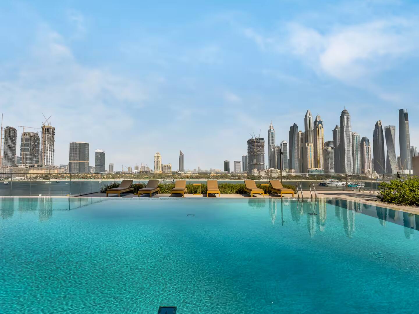 Cloudy blue sky over cityscape pool