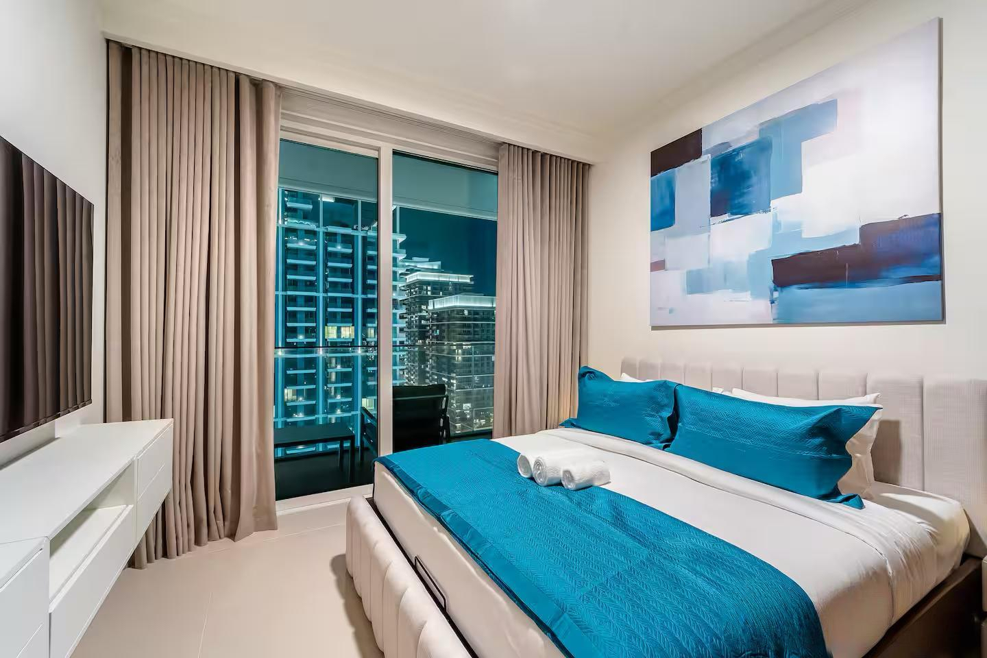 A cozy bedroom with furniture and bedding