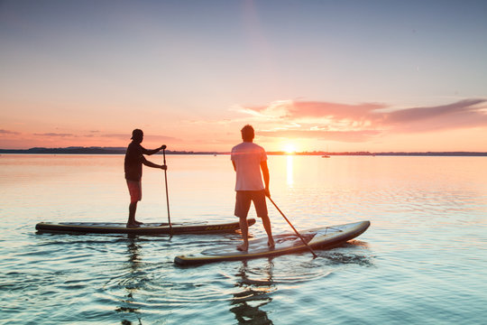 People fishing outdoors at sunset