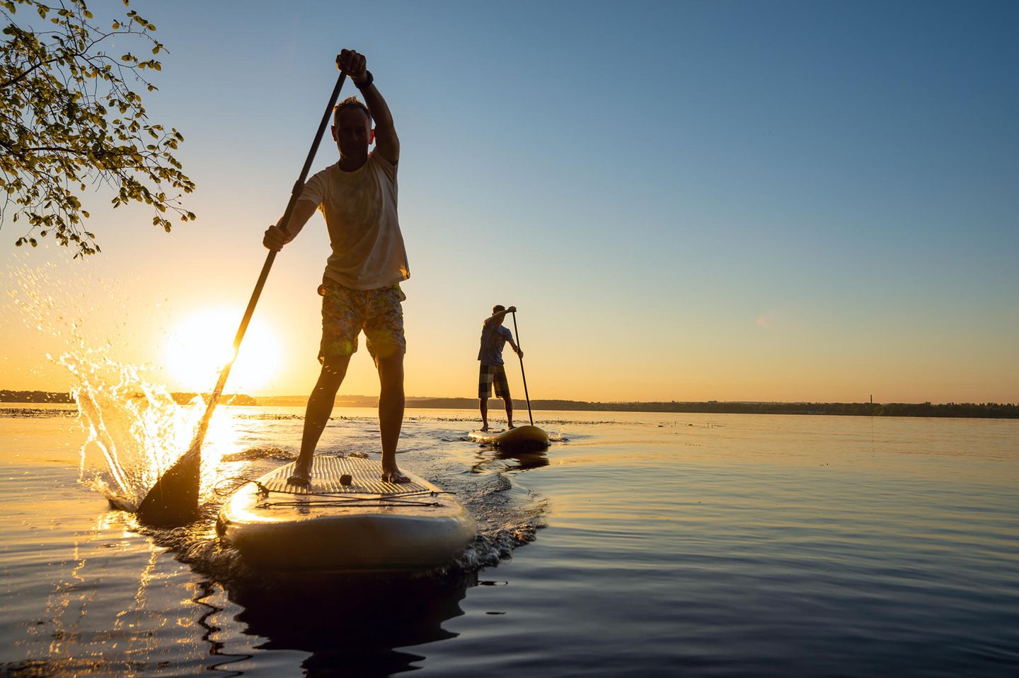 Fishing at lake during sunset